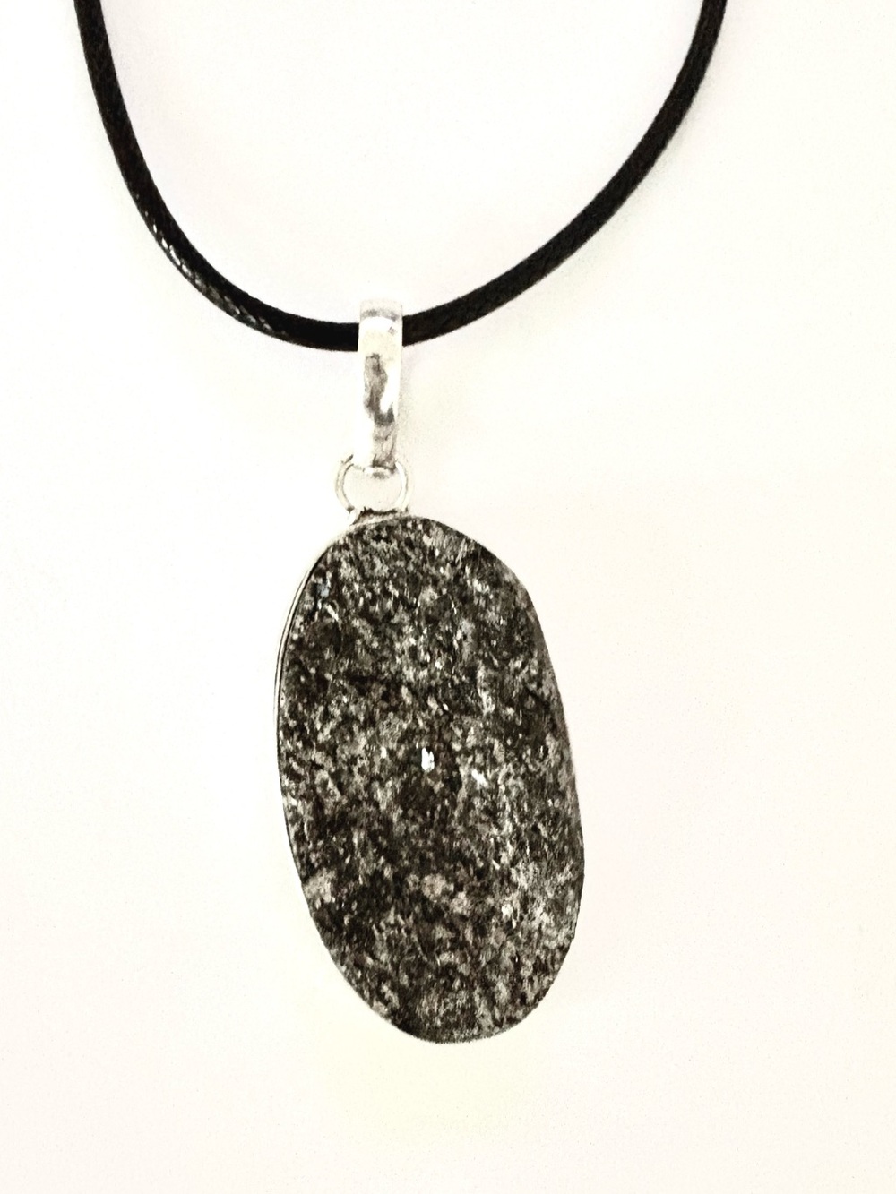 2 inch, natural, uneven Titanium Druzy pendant, on a  is on black leather chain.